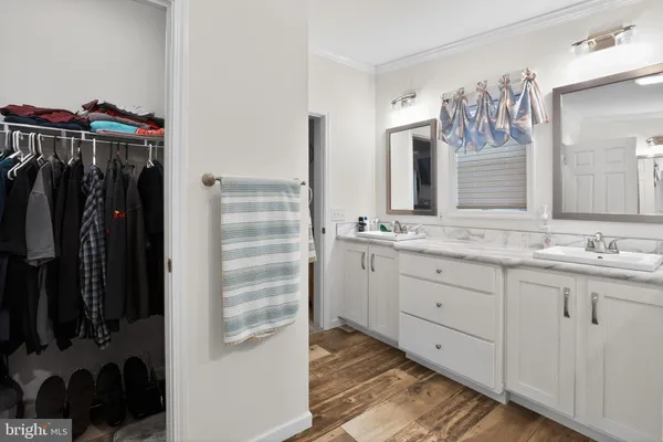 a bathroom with a double vanity sink and a mirror
