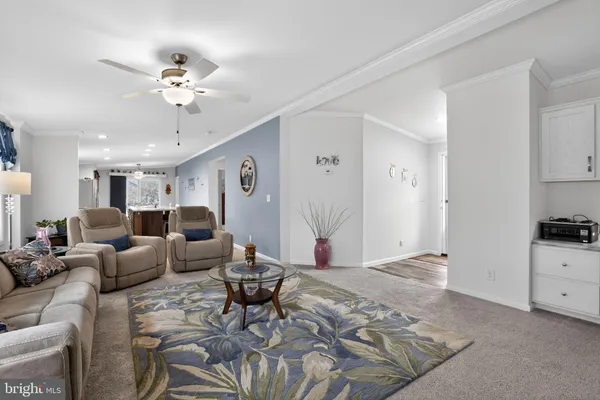 a living room with furniture and kitchen view