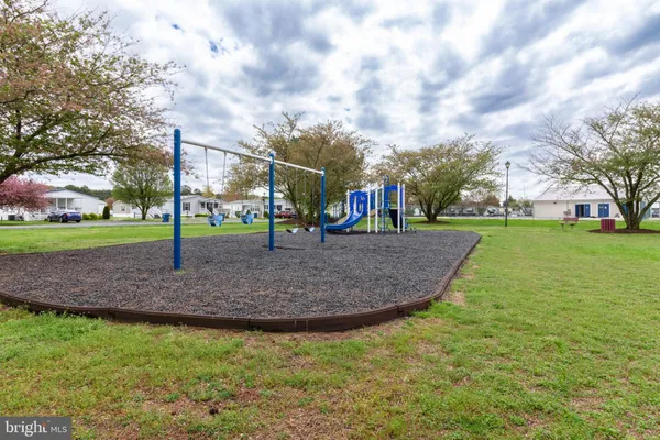 a view of outdoor space with playground and green space