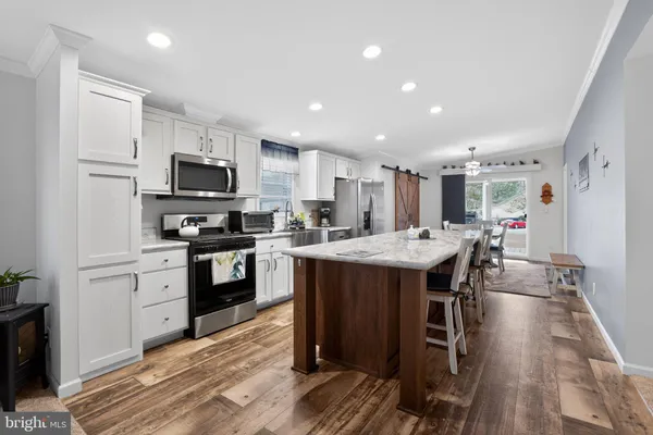 a kitchen with a sink appliances and cabinets