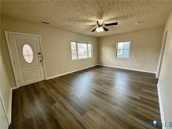 a kitchen with stainless steel appliances granite countertop a sink cabinets wooden floor and a window