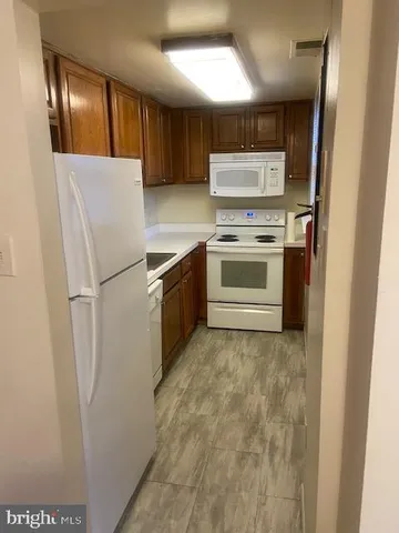a kitchen with granite countertop a refrigerator and a stove
