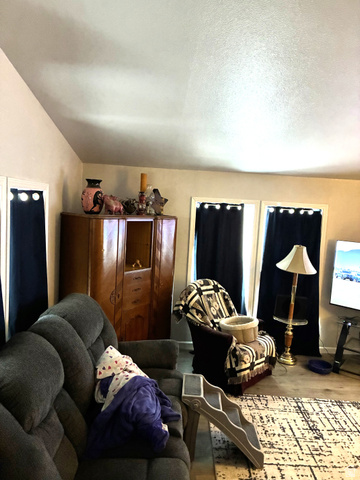 547 East 2000th Street North Vernal, UT 84078 - Photo 21 of 50 Vaulted ceiling with textured finish, light-toned walls, and wood-finish flooring
