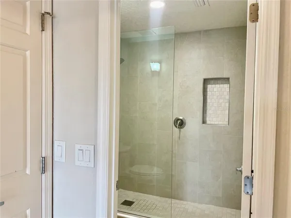 a bathroom with a glass shower door