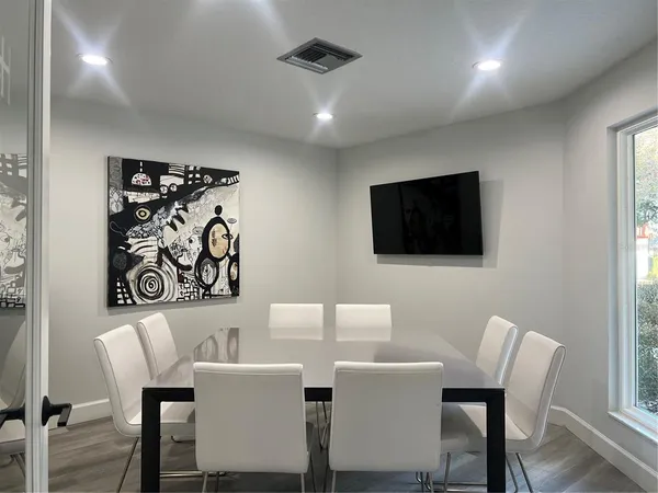 a view of a dining room with furniture and wooden floor
