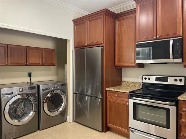 a kitchen with a refrigerator sink and cabinets