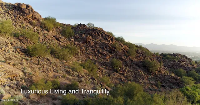a view of a large building with mountains in the background
