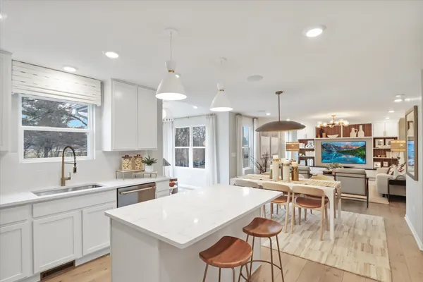 a large kitchen with a table and chairs