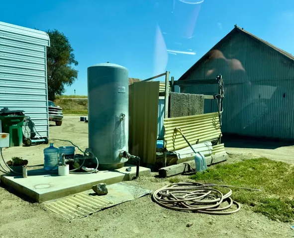 a view of a yard with wooden fence