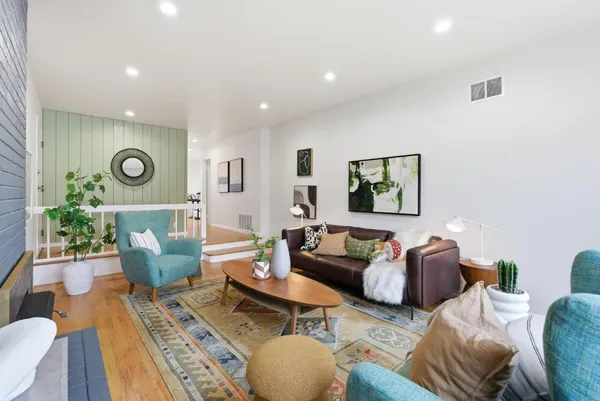 a living room with furniture and wooden floor