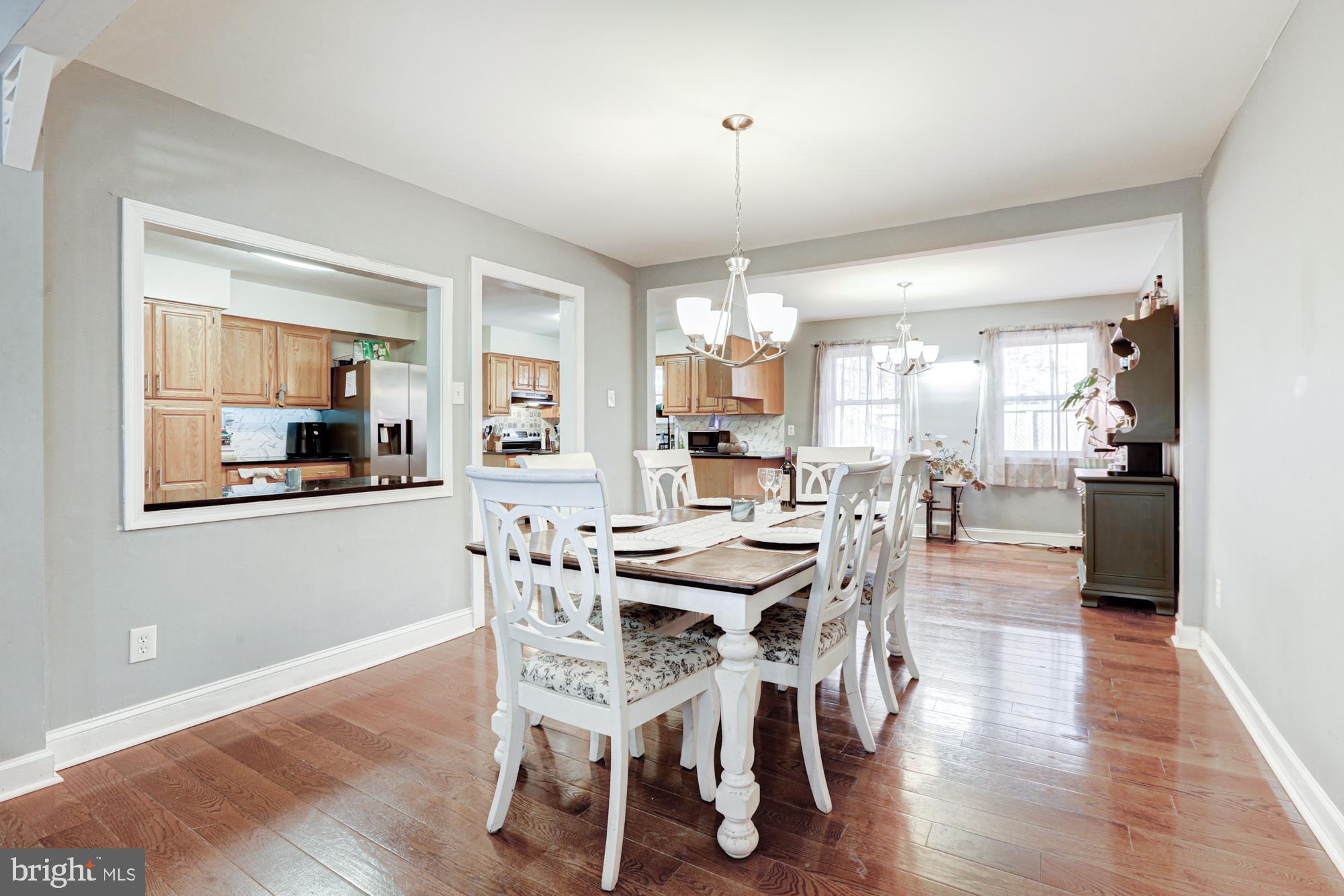 15 Evergreen Drive Newark, DE 19702 - Photo 16 of 85 a view of a dining room and livingroom with furniture wooden floor a chandelier