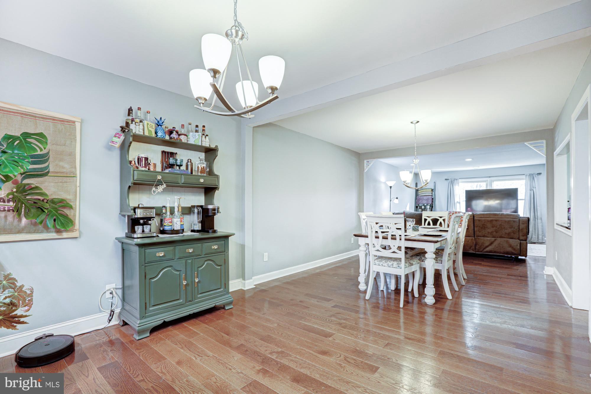15 Evergreen Drive Newark, DE 19702 - Photo 18 of 85 a dining room with wooden floor a chandelier a wooden table and chairs