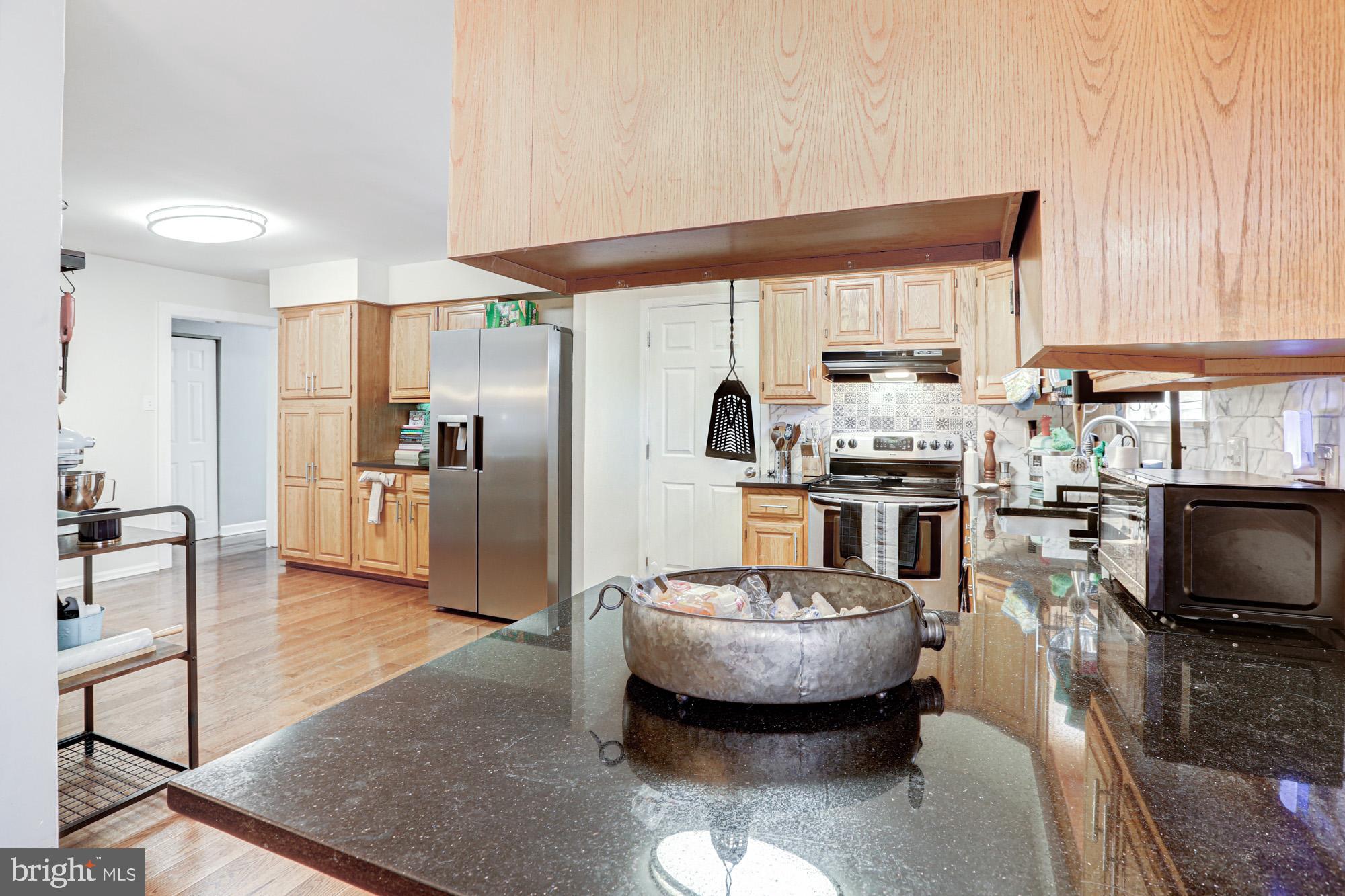 15 Evergreen Drive Newark, DE 19702 - Photo 25 of 85 a kitchen with stainless steel appliances kitchen island granite countertop a sink refrigerator and cabinets