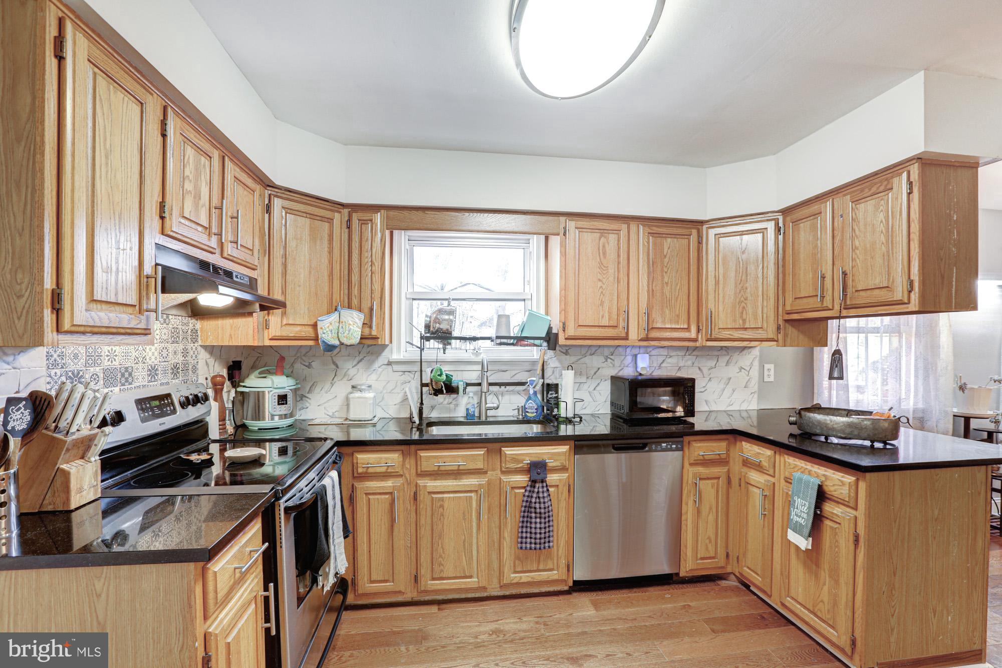 15 Evergreen Drive Newark, DE 19702 - Photo 27 of 85 a kitchen with stainless steel appliances granite countertop a stove a sink and a white cabinets