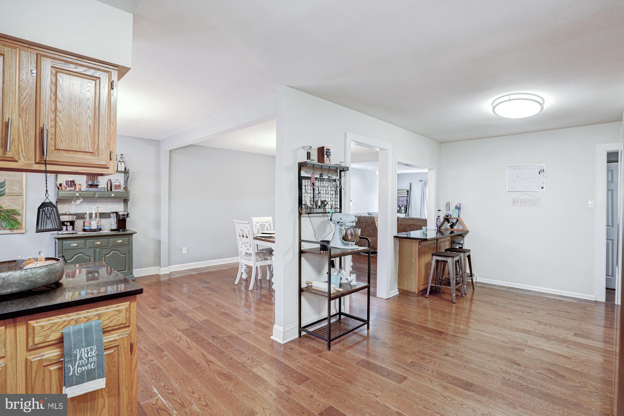 15 Evergreen Drive Newark, DE 19702 - Photo 32 of 85 a view of a kitchen with dining table chairs and wooden floor