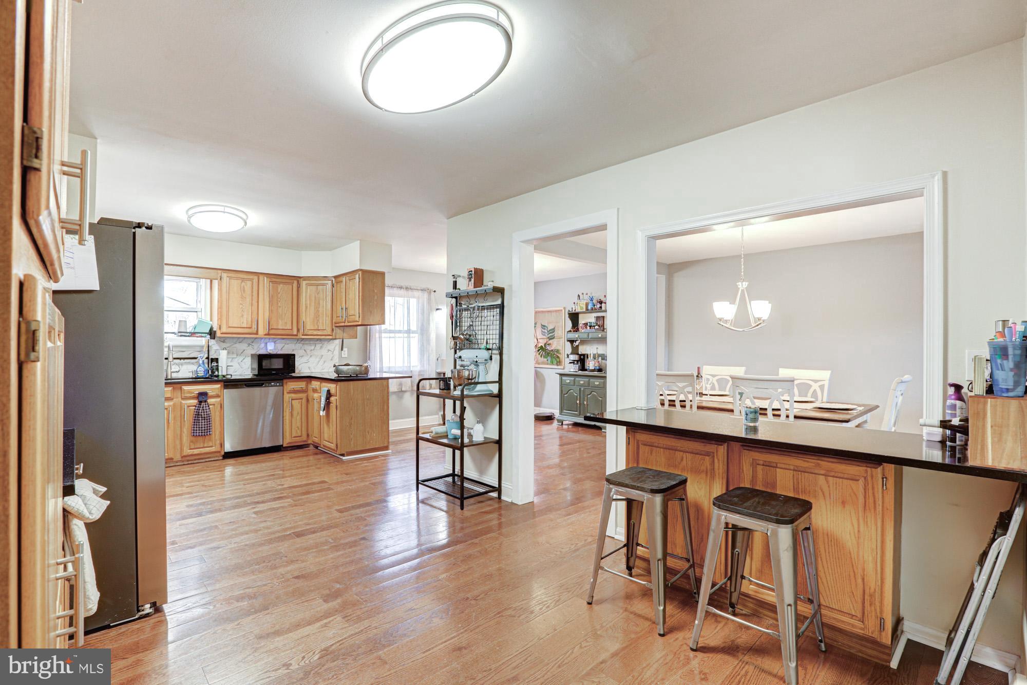 15 Evergreen Drive Newark, DE 19702 - Photo 34 of 85 a kitchen with kitchen island granite countertop wooden floors and stainless steel appliances