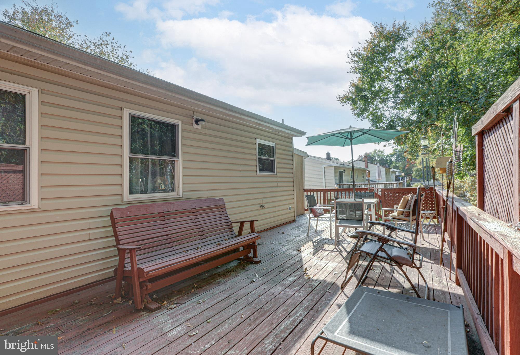 15 Evergreen Drive Newark, DE 19702 - Photo 64 of 85 a view of a patio with table and chairs with wooden floor and fence