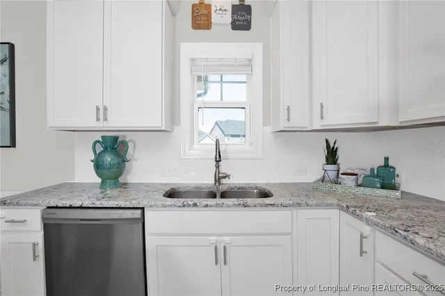 a kitchen with granite countertop cabinets
