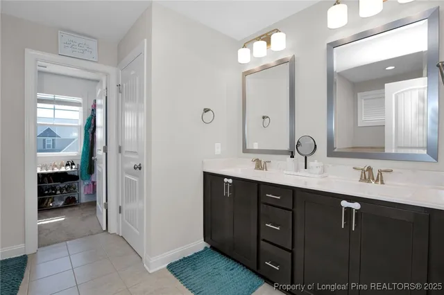 a bathroom with a double vanity sink and a mirror