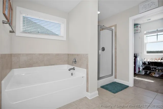 a white bath tub sitting next to a window