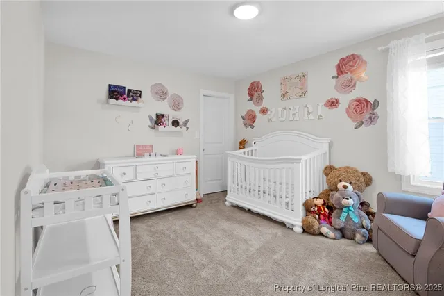a bedroom with baby bed and a dresser