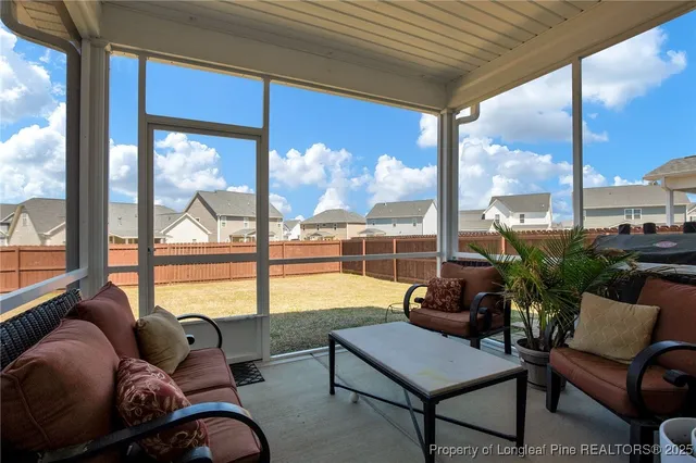 a living room with furniture and a floor to ceiling window