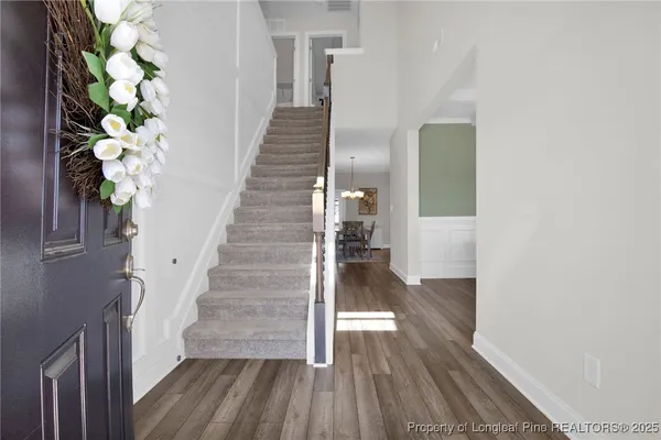 a view of entryway and hall with wooden floor