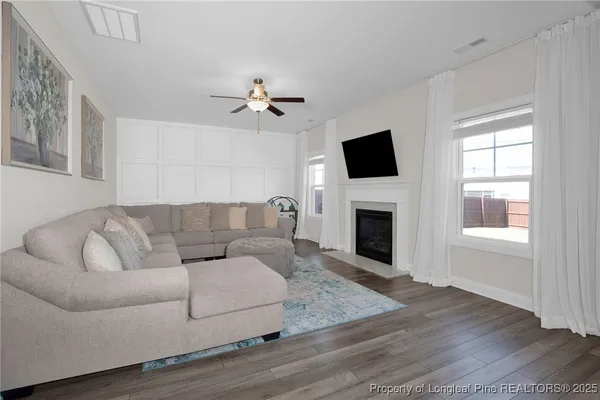 a living room with furniture fireplace and flat screen tv
