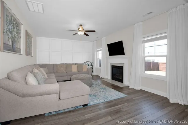 a living room with furniture fireplace and flat screen tv