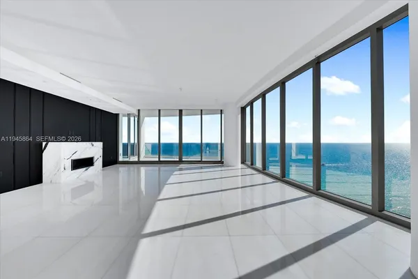 a spacious bedroom with a large bed and a large window