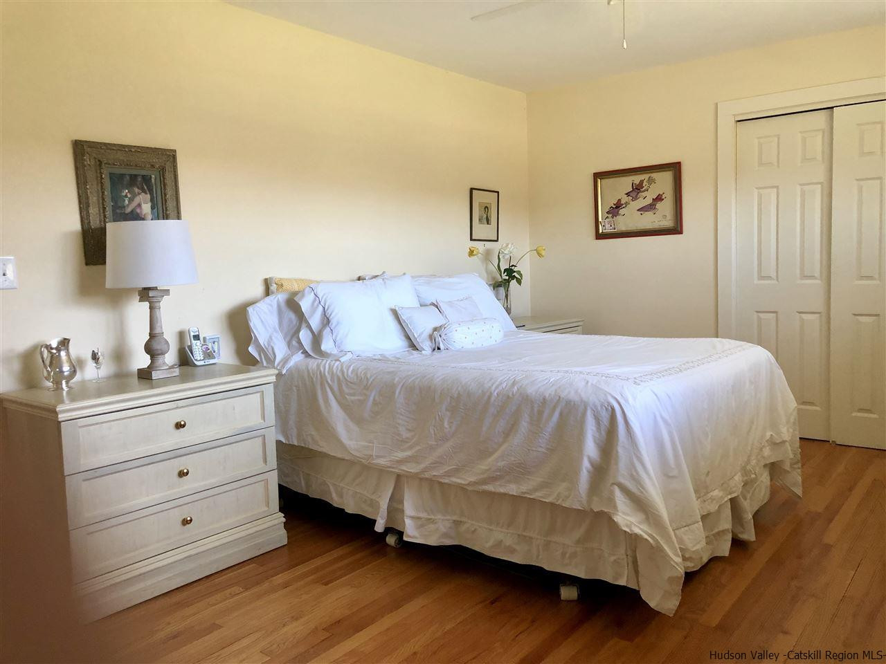 52 Buck Road Stone Ridge, NY 12484 - Photo 13 of 35 a bedroom with a bed and a night stand