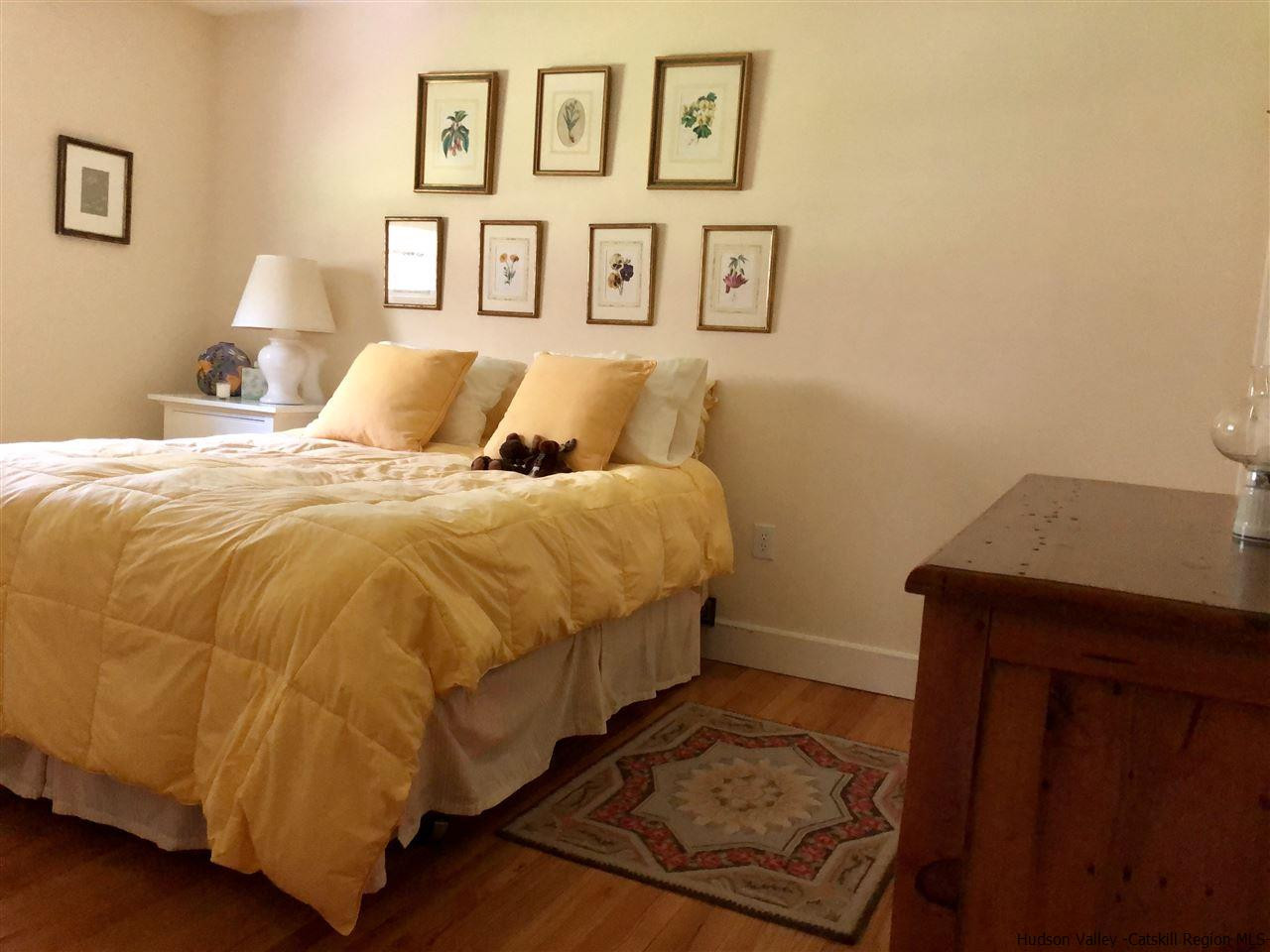 52 Buck Road Stone Ridge, NY 12484 - Photo 21 of 35 a bedroom with a bed and painting on the wall