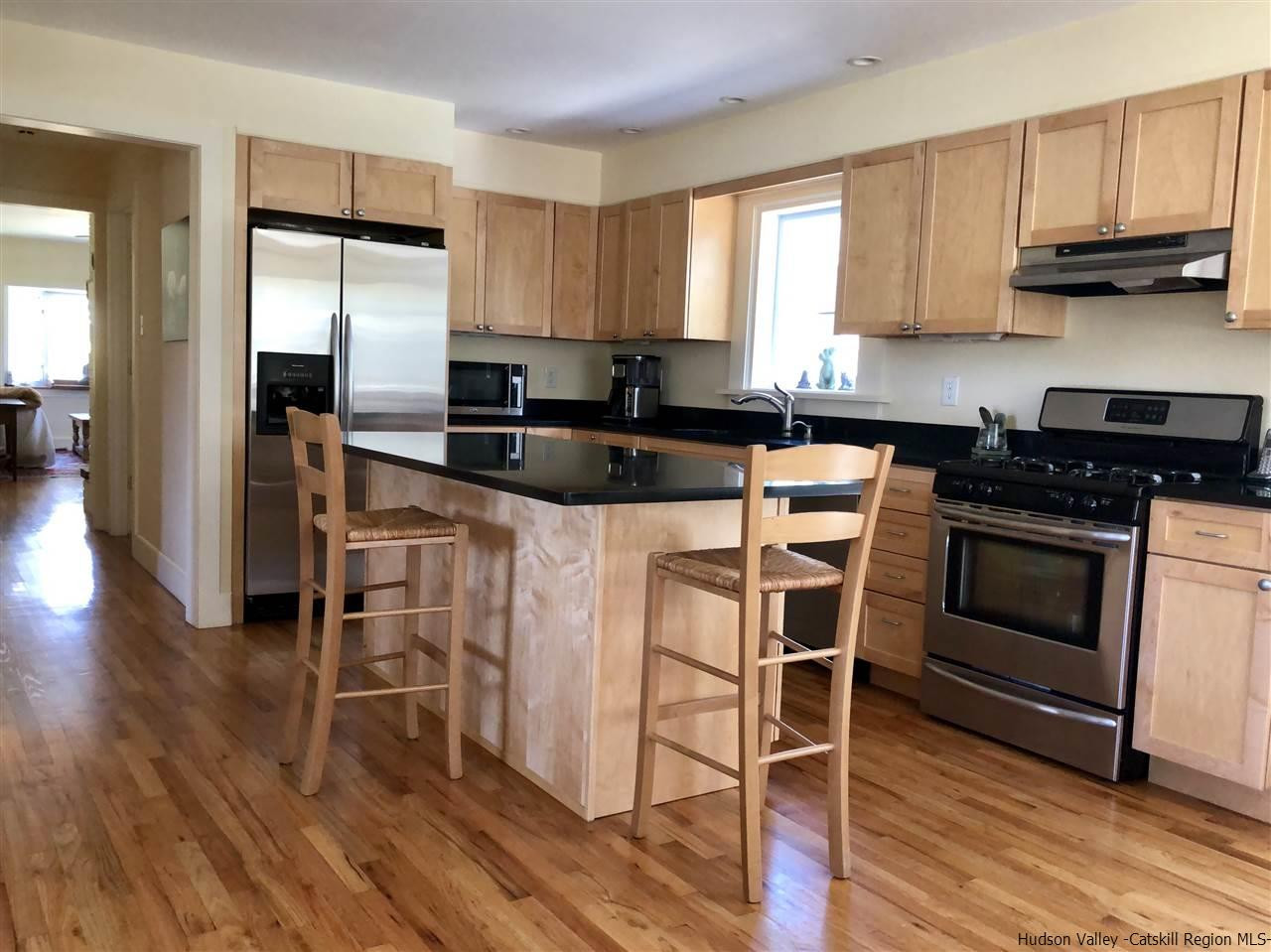52 Buck Road Stone Ridge, NY 12484 - Photo 8 of 35 a kitchen with granite countertop a stove a sink dishwasher and a refrigerator