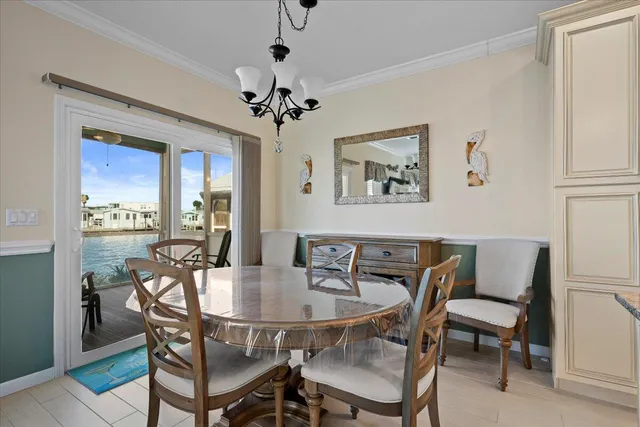 a dining room with furniture a flat screen tv and a large window