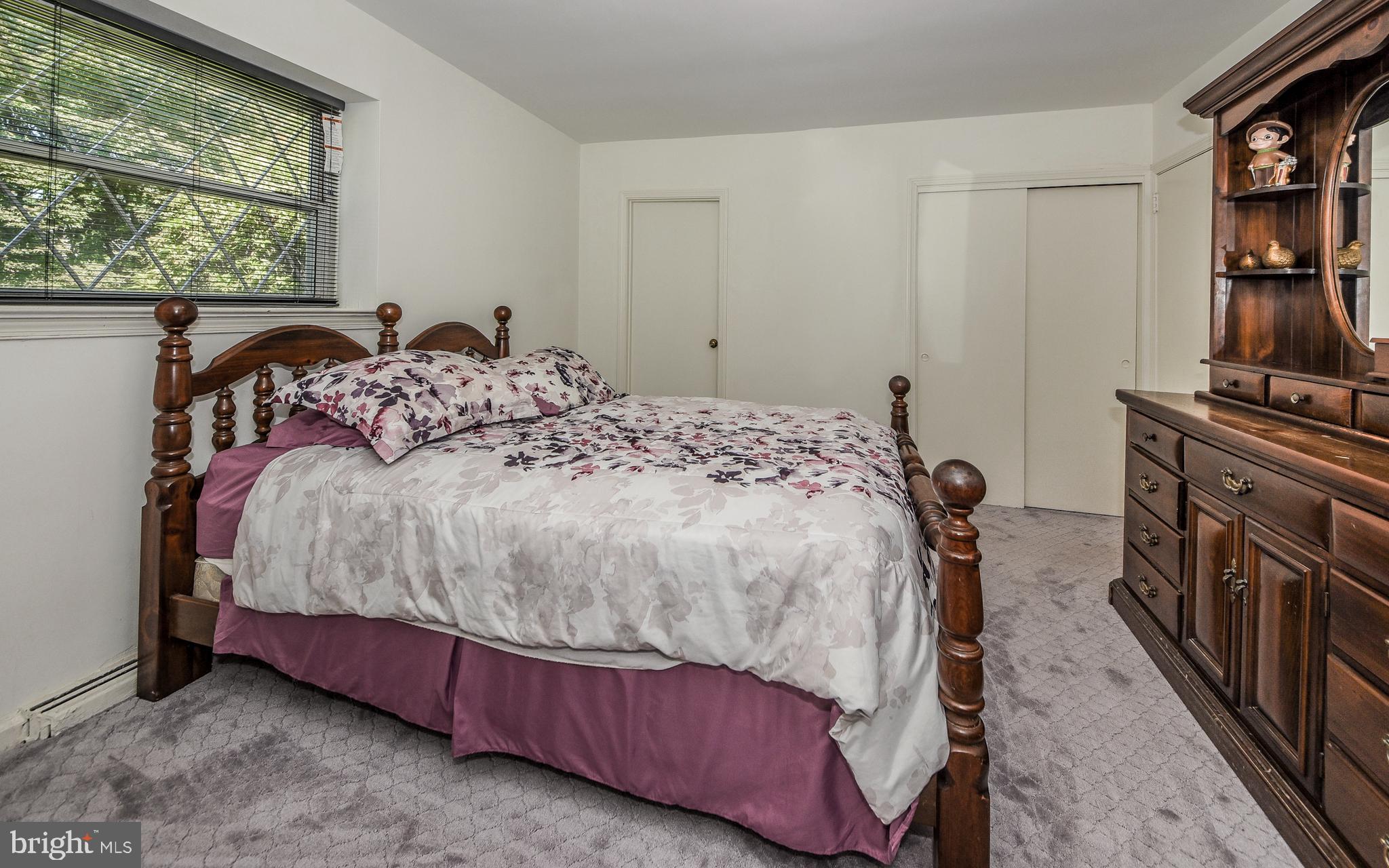 2083 Williamsburg Road Huntingdon Valley, PA 19006 - Photo 18 of 46 a bed sitting in a bedroom next to a window