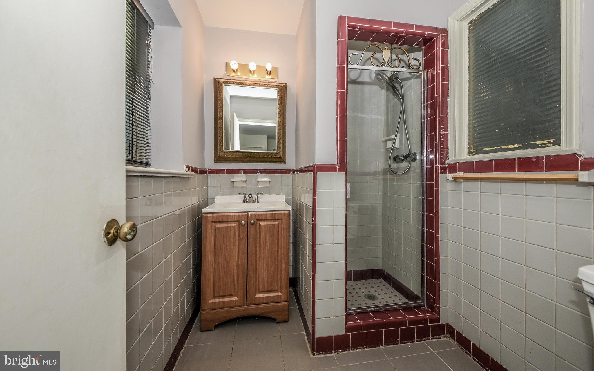 2083 Williamsburg Road Huntingdon Valley, PA 19006 - Photo 19 of 46 a bathroom with a sink mirror and shower