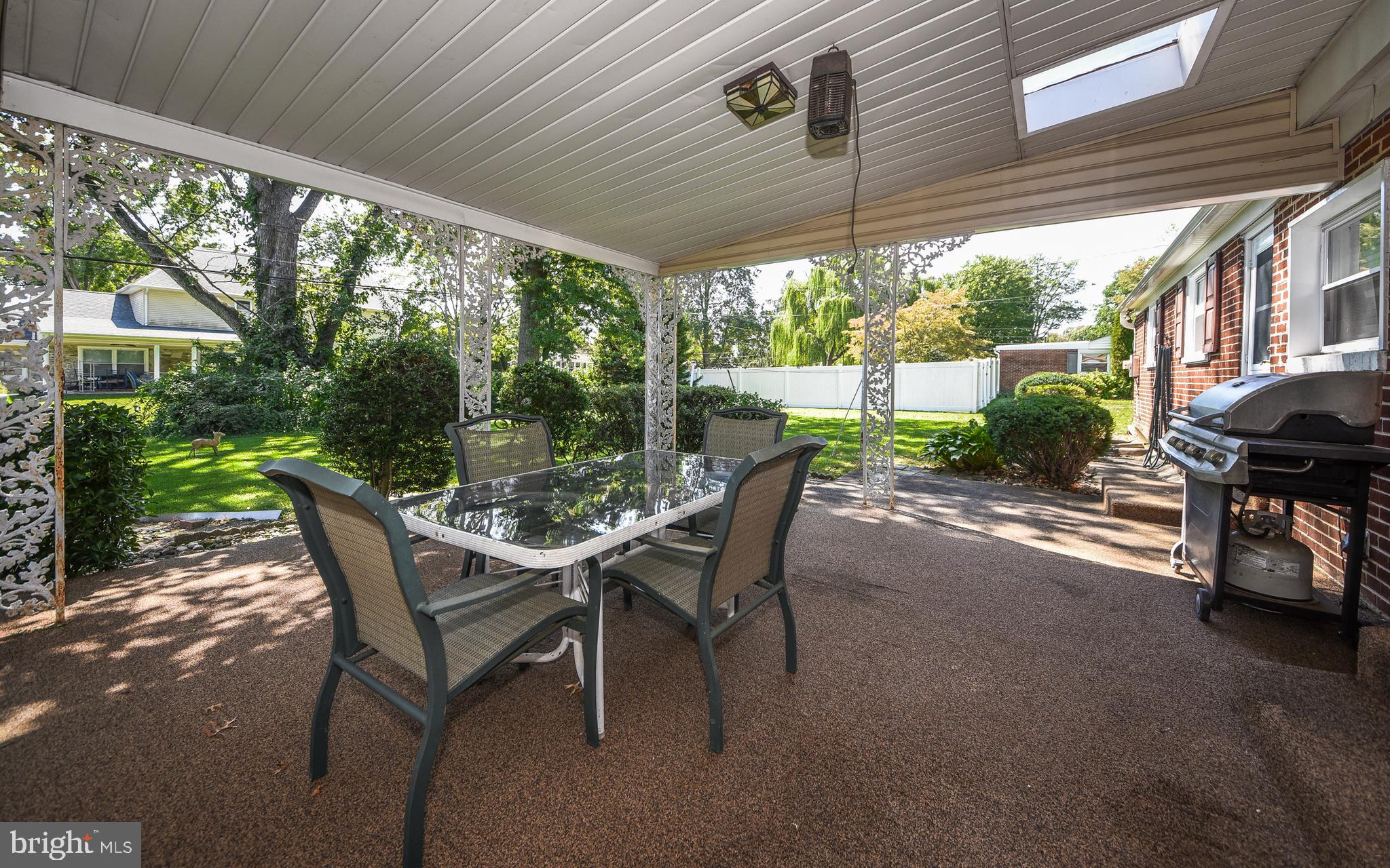 2083 Williamsburg Road Huntingdon Valley, PA 19006 - Photo 34 of 46 a view of a patio with a table chairs and a yard