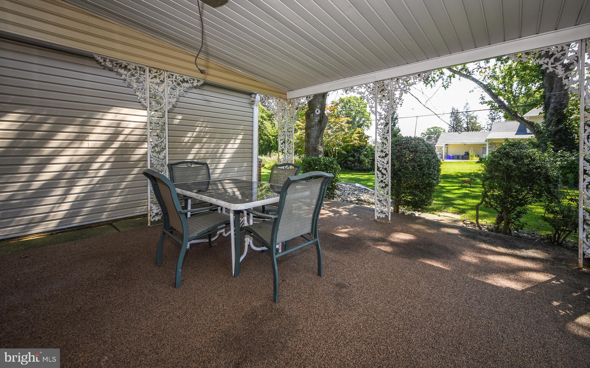2083 Williamsburg Road Huntingdon Valley, PA 19006 - Photo 35 of 46 a view of a patio with table and chairs next to a yard