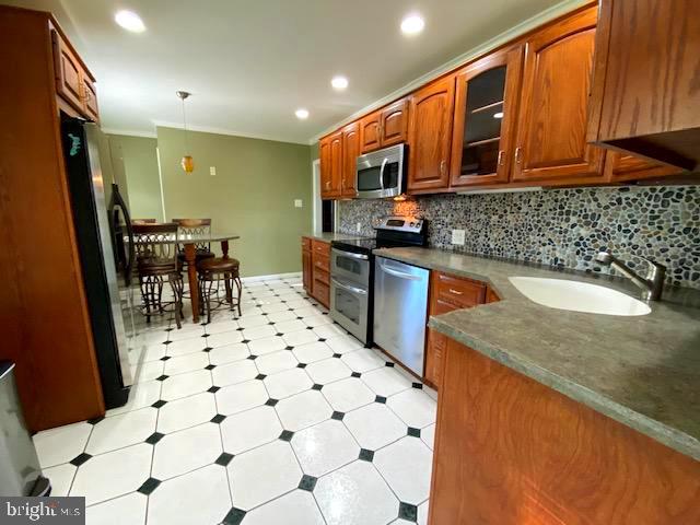 2083 Williamsburg Road Huntingdon Valley, PA 19006 - Photo 40 of 46 a kitchen with stainless steel appliances granite countertop a sink a stove a microwave a refrigerator a microwave oven with white cabinets and wooden floor