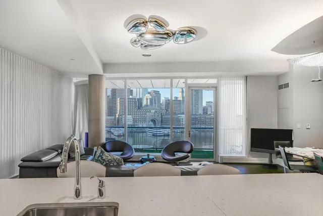 a view of a livingroom with furniture and a large window