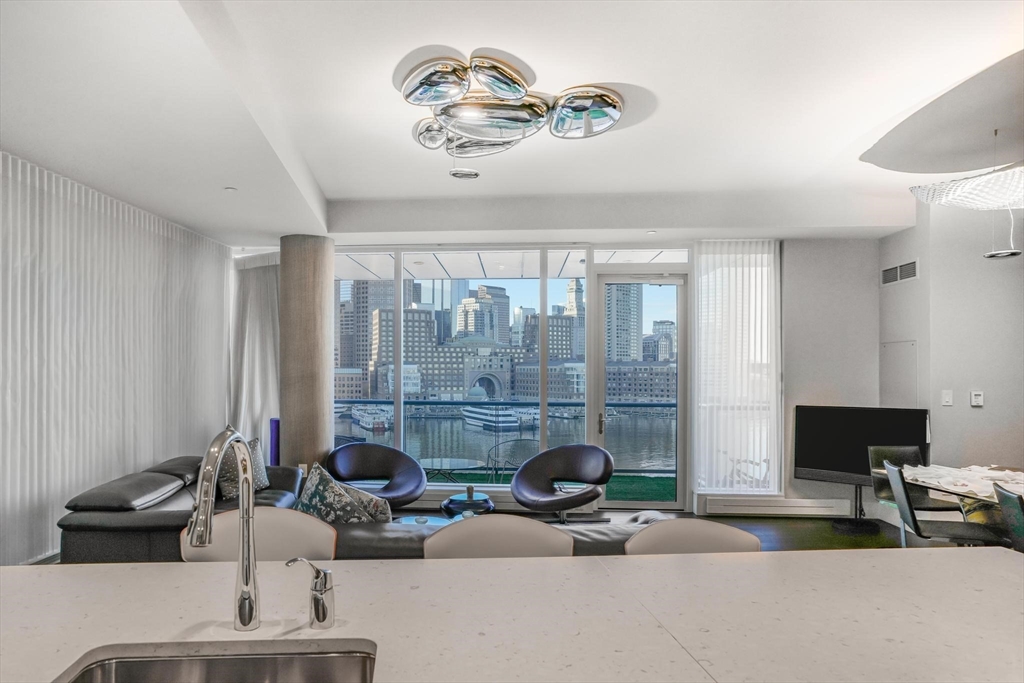 a view of a livingroom with furniture and a large window