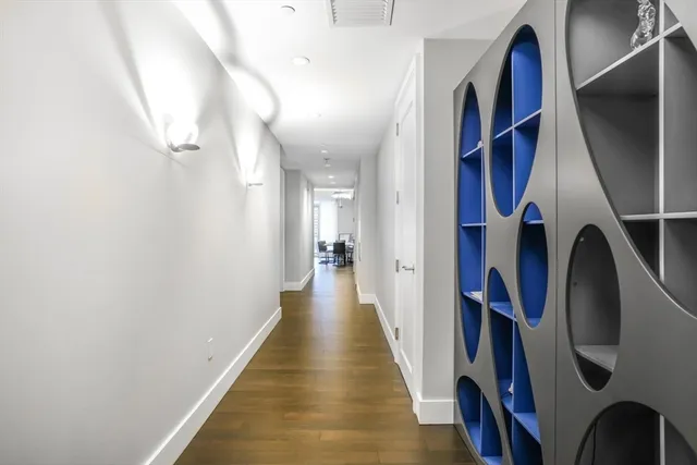 a view of a hallway with wooden floor and stairs