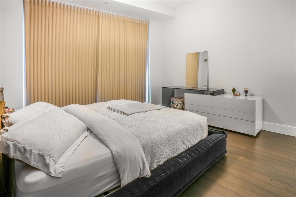 22 Liberty Drive, Unit 7M Boston, MA 02210 - Photo 17 of 31 a bedroom with a bed and wooden floor