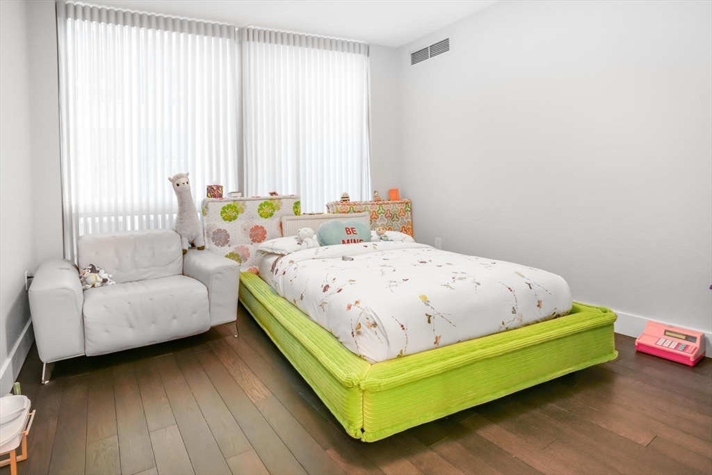 22 Liberty Drive, Unit 7M Boston, MA 02210 - Photo 20 of 31 a bedroom with a bed and a couch