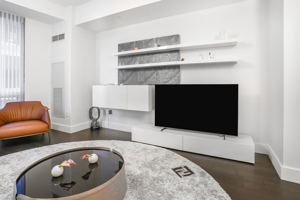 22 Liberty Drive, Unit 7M Boston, MA 02210 - Photo 23 of 31 a living room with a fireplace and a couch