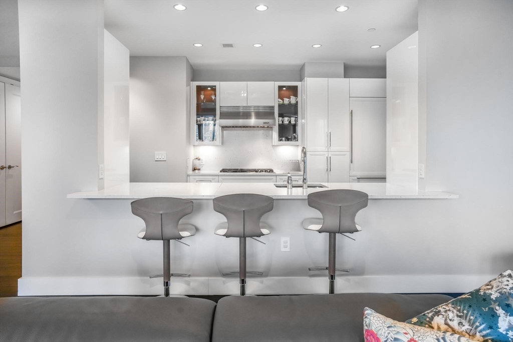 22 Liberty Drive, Unit 7M Boston, MA 02210 - Photo 9 of 31 a kitchen with stainless steel appliances kitchen island granite countertop a sink and a cabinets