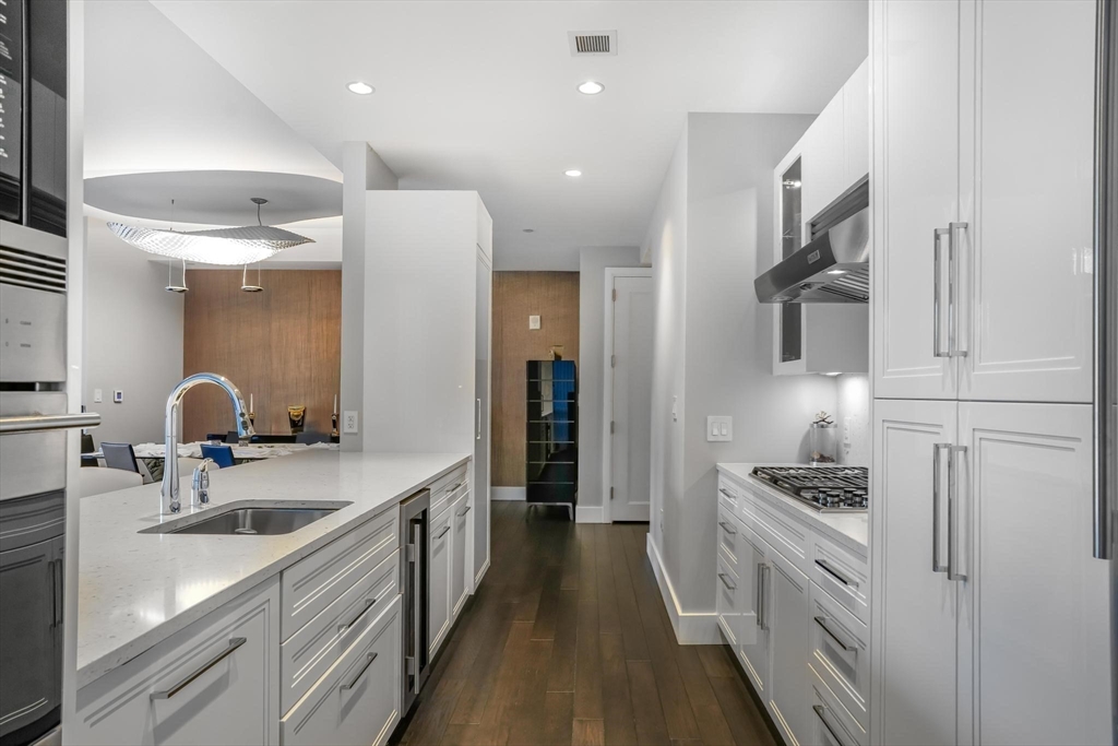 22 Liberty Drive, Unit 7M Boston, MA 02210 - Photo 10 of 31 a kitchen with white cabinets and appliances