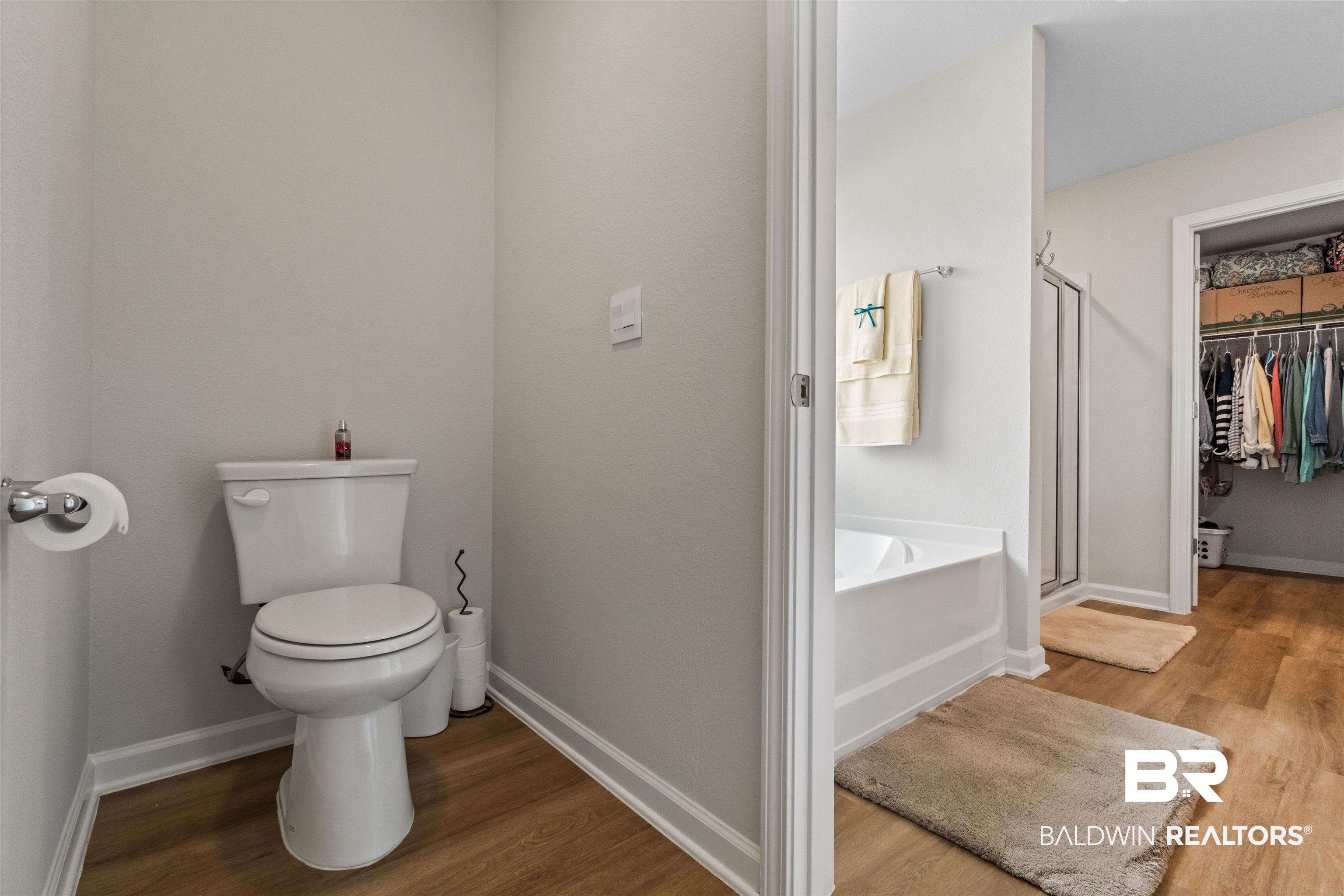 24390 Ringneck Loop Elberta, AL 36530 - Photo 22 of 39 Bathroom with toilet, plus walk in shower, and hardwood / wood-style flooring