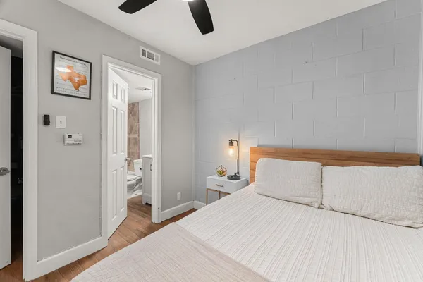 a bedroom with a bed and a painting on the wall