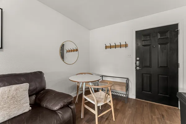 a view of a livingroom with furniture and wooden floor